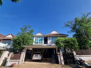 Two-story residential building with garage and driveway