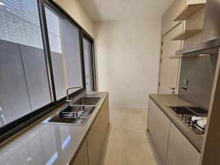 Modern kitchen with large windows and sleek countertops