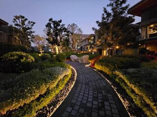 Beautifully landscaped garden with pathway and evening lighting