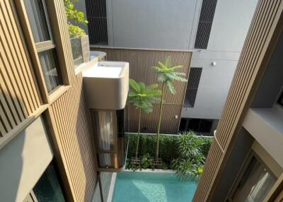 Modern building with swimming pool and greenery