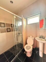 A modern bathroom with a shower and toilet