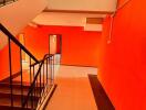 Interior view of building staircase and hallway with brightly colored walls