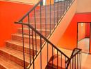 Staircase with black railings and wooden steps