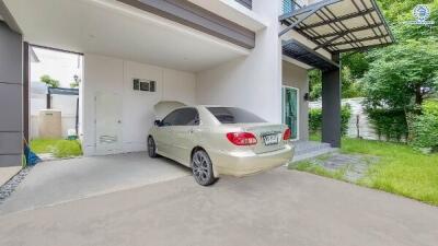 Front view of a building with attached garage and parked car