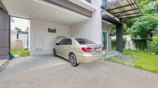 Front view of a building with attached garage and parked car