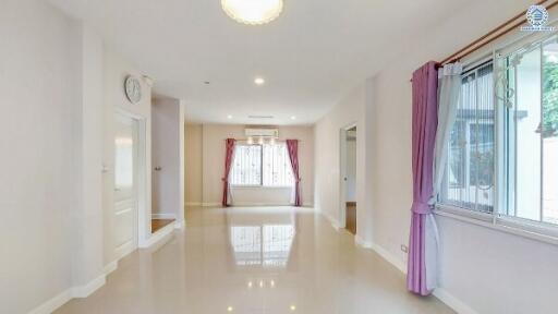 Spacious living room with shiny floor and large windows