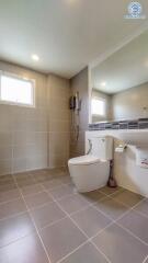 Modern bathroom with white fixtures and large mirror