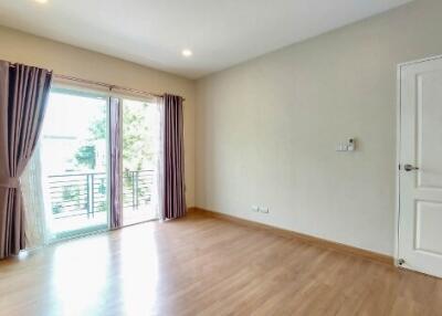 Spacious bedroom with large window and balcony access