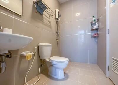 Modern bathroom with toilet, sink, and shower