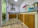 Modern kitchen with wooden cabinets, stainless steel range hood, and glass door