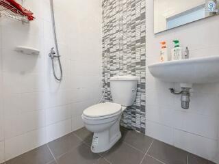 Modern bathroom with shower, toilet, and sink