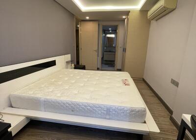 Modern bedroom with a double bed and wooden flooring