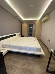 Modern bedroom with a double bed and wooden flooring