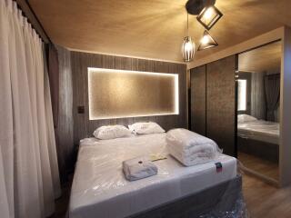 Modern bedroom with double bed, large closet, and ambient lighting