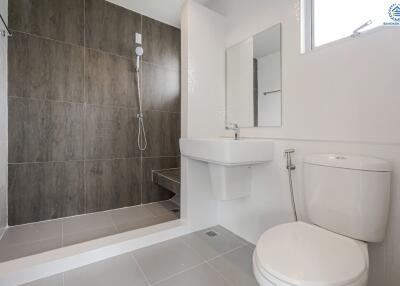 Modern bathroom with shower, sink, and toilet