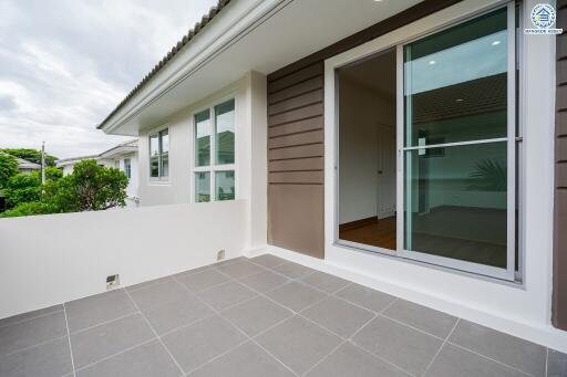 Spacious balcony area with sliding glass doors