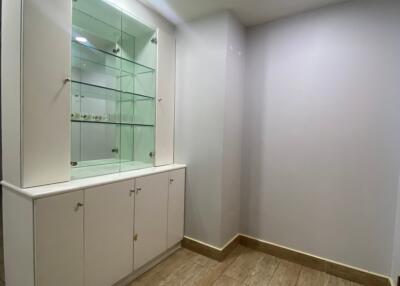 Well-lit hallway with built-in storage and display shelves