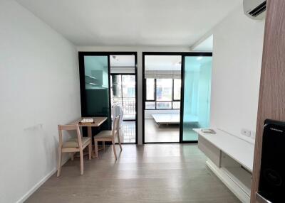 Contemporary living room with dining area and glass partitions