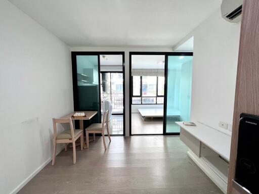 Contemporary living room with dining area and glass partitions