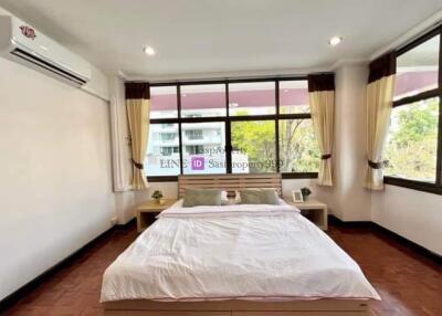 Spacious bedroom with large windows and natural lighting