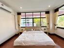 Spacious bedroom with large windows and natural lighting