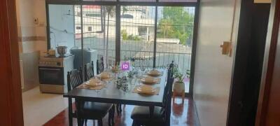 Dining area with table set for six next to a large window