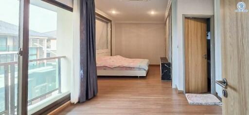 Spacious bedroom with large window and balcony access