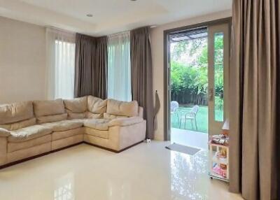 Spacious living room with large windows and garden access