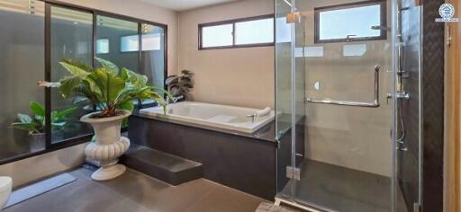 Modern bathroom with large bathtub and glass shower enclosure