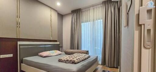 Bedroom with double bed and floor-to-ceiling windows