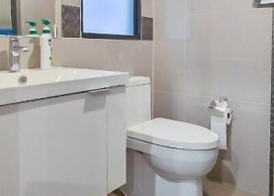 Modern bathroom with white fixtures and a large mirror