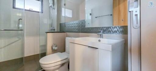 Modern bathroom with sink, toilet, and shower