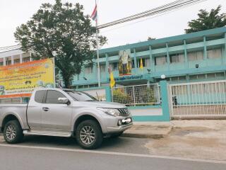 Street view of a building with a parked vehicle in front