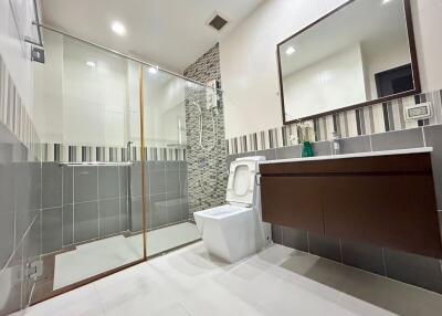 Modern bathroom with shower, toilet, and vanity