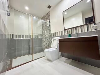 Modern bathroom with shower, toilet, and vanity