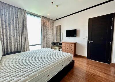 Modern bedroom with wooden floor and natural light