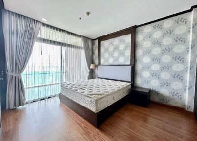 Spacious bedroom with modern decor and large window