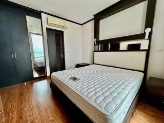 Modern bedroom with wooden flooring and queen size bed
