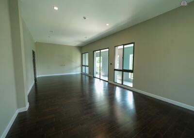 Spacious living area with wooden floors and large windows