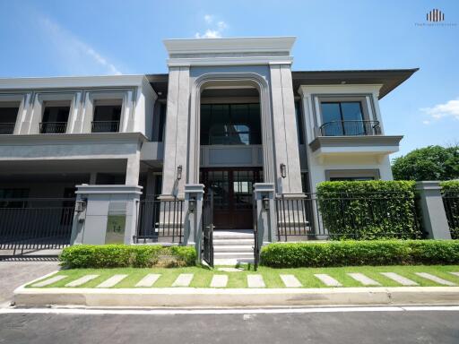 Modern two-story building with a manicured lawn and large windows