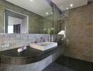 Modern bathroom with glass shower and granite countertop sink