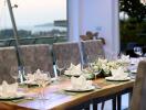 Elegant dining room with a set dining table and a scenic view in the background