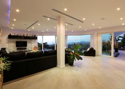 Spacious and well-lit living room with modern furnishings and large windows
