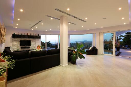 Spacious and well-lit living room with modern furnishings and large windows