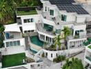 Modern multi-story house with rooftop solar panels and lush greenery