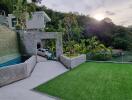 Exterior view with lawn, stone wall, and carport