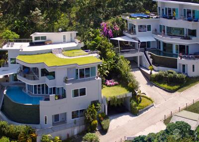 Aerial view of modern, multi-level homes with lush greenery