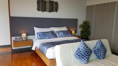 Modern bedroom with double bed and blue accents