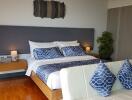 Modern bedroom with double bed and blue accents