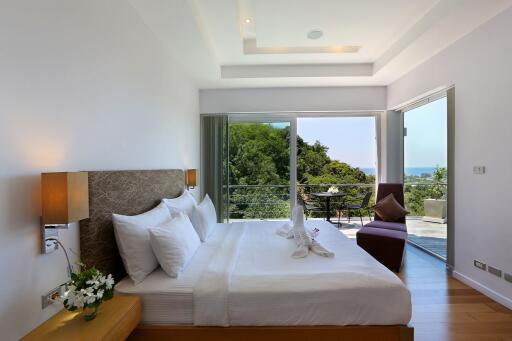 Modern bedroom with large windows and a balcony view